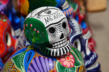 selective focus photography of white and green floral skull figurine thumbnail