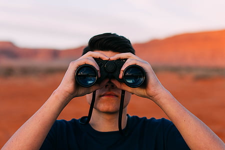 man looking through binoculars thumbnail