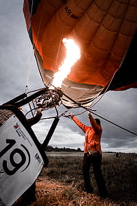 man holding gray hot air balloon thumbnail