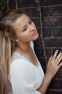 photo of man in white dress standing beside wall thumbnail