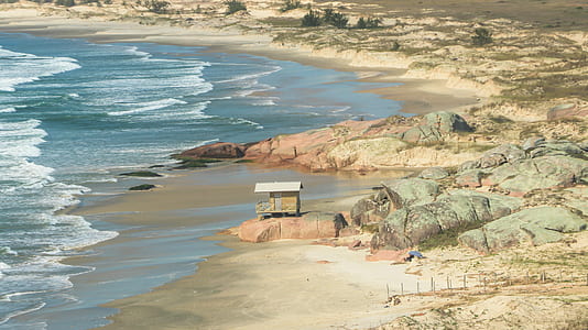 gray house near seashore thumbnail
