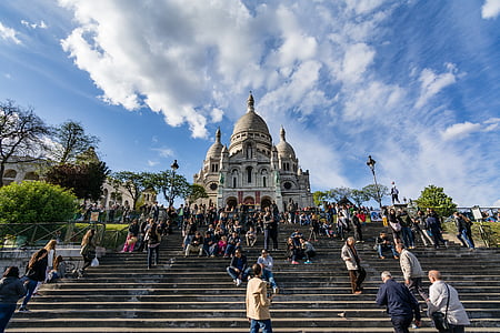 people gathering in front of concrete mosque at daytime thumbnail