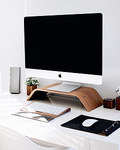 silver iMac on brown wooden rack thumbnail