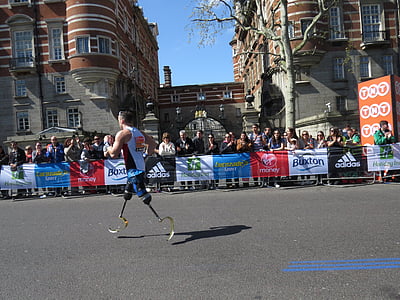 man with prosthetic legs running on road thumbnail