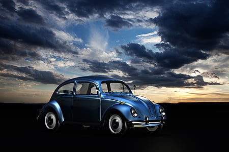 photo of blue new beetle under sky thumbnail