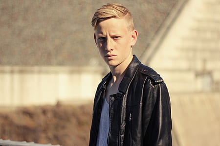 man wearing black leather zip-up jacket during daytime thumbnail