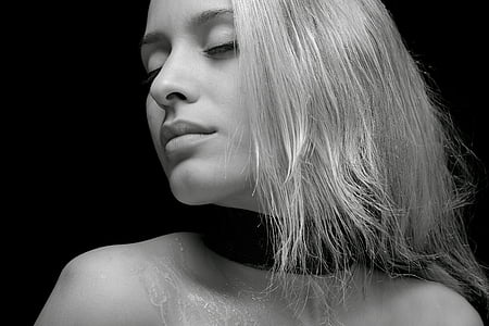 greyscale photo of woman with black top in black background thumbnail