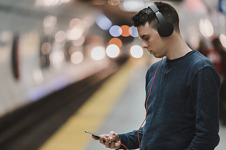 person listening to music while holding phone thumbnail