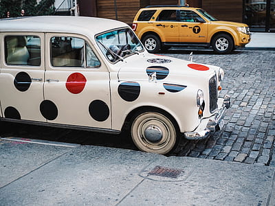 classic white, black and red polka dot painted hardtop suicide door sedan parked at daytime thumbnail