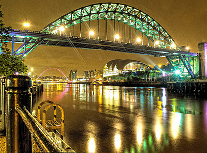 lighted green bridge at night time thumbnail