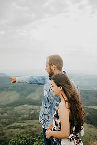 man and woman standing on mountain thumbnail
