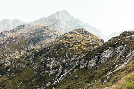 mountain range covered with green grass at daytime thumbnail