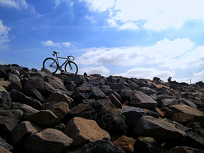 low-angle view of bicycle on rock cliff thumbnail