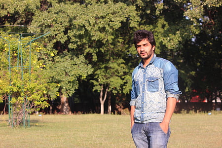 man standing on field with hands on pockets thumbnail