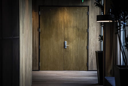 closed brown wooden double door thumbnail