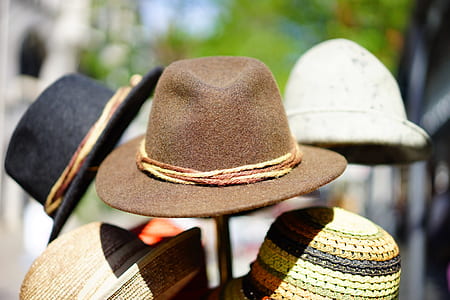 selective focus photography of fedora hats on rack thumbnail
