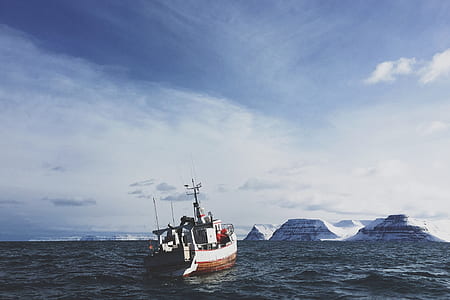 white fishing boat on body of water during daytime thumbnail