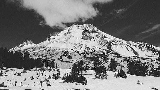 grayscale photography of glacier mountain under cloudy skies thumbnail