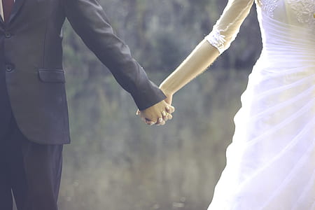 bride and groom holding hands during daytime thumbnail