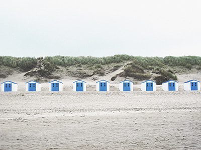 white-and-blue sheds on seashore thumbnail
