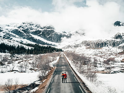 two person standing on gray top road thumbnail