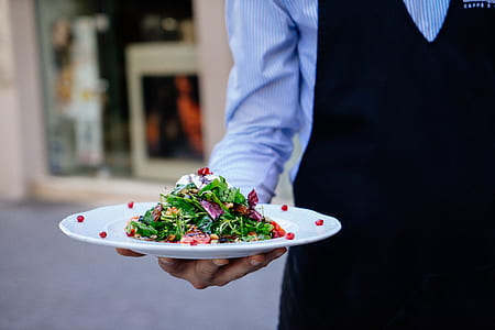 waiter holding salad platter thumbnail