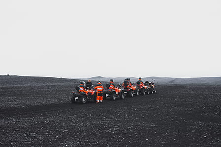 group of people riding vehicle on open field thumbnail