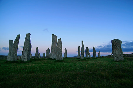 photography of rock formation on green grass field thumbnail