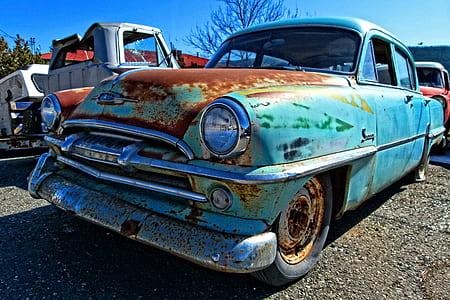 teal car under blue clouds during daytime thumbnail