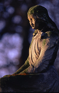 mossy statue of sitting woman selective focal photo thumbnail