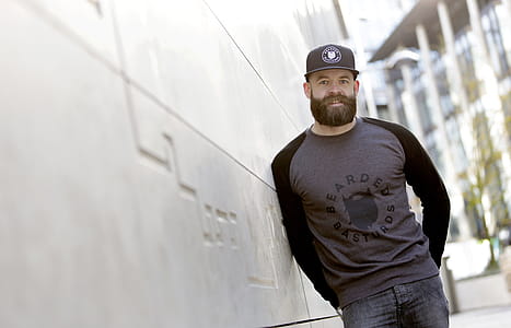 Man Leaning Against the White Concrete Wall thumbnail