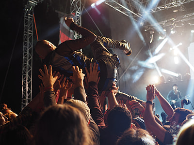 crowd of people lifting man in concert thumbnail