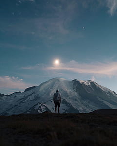 photo of person standing infront of mountain thumbnail