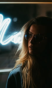 portrait photo of a woman standing in front of a neon signage thumbnail