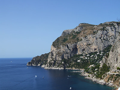 cliff over body of water at daytime thumbnail