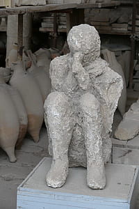 human statuette on gray wooden box thumbnail