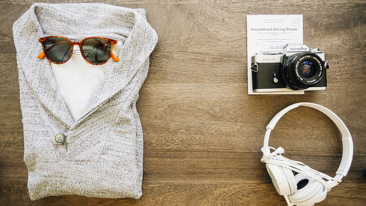 flat lay photography of DSLR camera, headphones, and polo shirt thumbnail