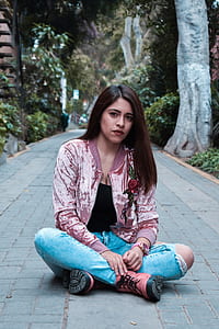 woman wearing distressed jeans sitting on floor thumbnail