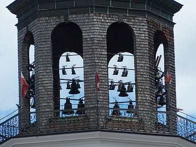close-up photo of gray concrete building with bells thumbnail