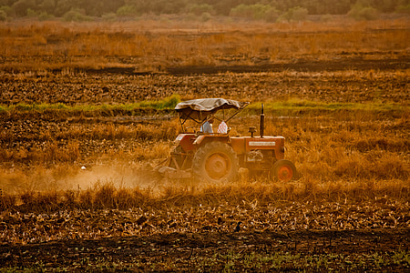 red tractor on brown field thumbnail