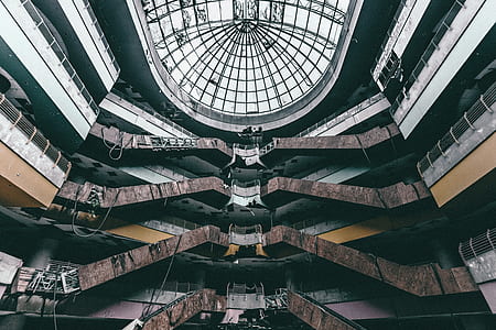 low-angle photography of gray, brown, and black building interior with glass dome room thumbnail