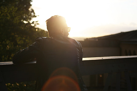 man wearing black suit during sunset thumbnail