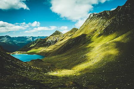 photography of green mountains under clear blue sky during daytime thumbnail