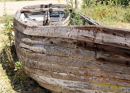 brown wooden boat on green grass field at daytime thumbnail