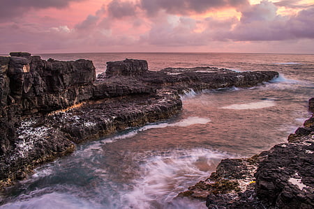 body of water and rock formations thumbnail