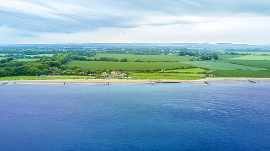 green field near sea thumbnail