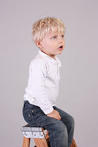 boy wearing white long-sleeved polo shirt and blue denim pants sitting on ladder thumbnail