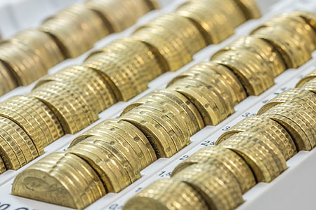 stack of gold-colored coins on box thumbnail