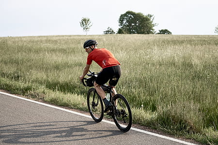 man riding road bike on road thumbnail