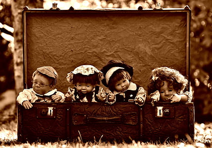 four porcelain doll on suit case thumbnail